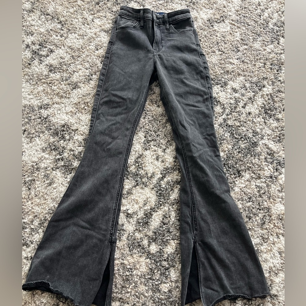 Black Hollister Flare Jeans, with a slit on the inside of the leg.